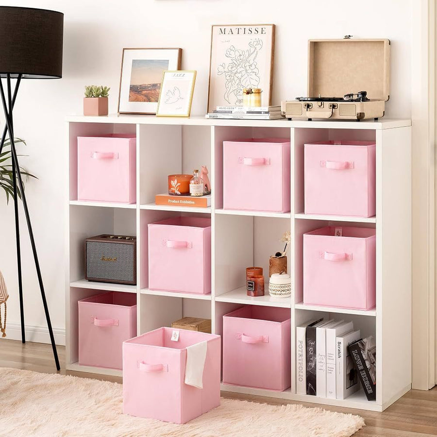 White cube storage shelf with pink fabric bins and decorative accessories